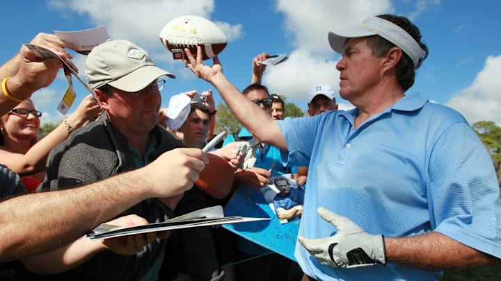 New England Patriots head coach Bill Belichick signs autographs during his pro-am appearance with golfing great Greg Norman, golf star Lexi Thompson, former NFL quarterback and TV commentator Joe Theismann and musician Kenny G at the Honda Classic in 2012.