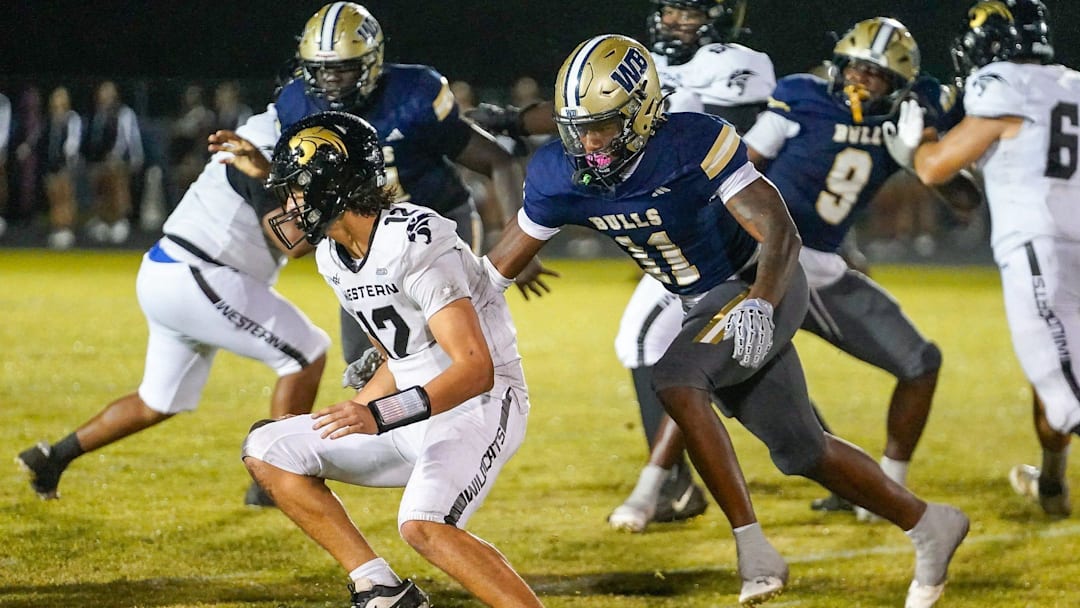 West Boca defensive end Demetrius Geathers Jr. (11) sacks Western quarterback Jack Spader (12) during the fourth quarter in a 35-0 victory over Western on Oct. 3, 2025, in Boca Raton, FL.