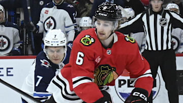 Apr 12, 2025; Chicago, Illinois, USA;  Chicago Blackhawks defenseman Sam Rinzel (6) and Winnipeg Jets center Vladislav Namestnikov (7) chase the puck during the first period at United Center. Mandatory Credit: Matt Marton-Imagn Images