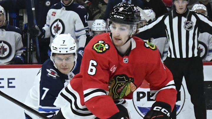 Apr 12, 2025; Chicago, Illinois, USA;  Chicago Blackhawks defenseman Sam Rinzel (6) and Winnipeg Jets center Vladislav Namestnikov (7) chase the puck during the first period at United Center. Mandatory Credit: Matt Marton-Imagn Images