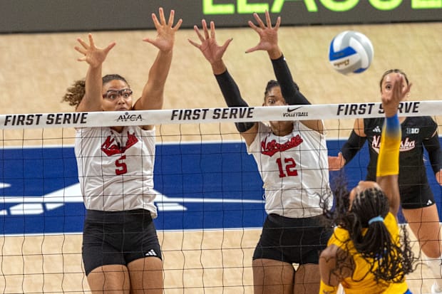Nebraska middle blocker Rebekah Allick blocks an attack from Pitt's Sophia Gregoire.