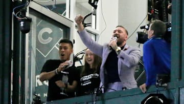 MMA fighter Conor McGregor sings the seventh inning stretch during a game between the Chicago Cubs and the Minnesota Twins.