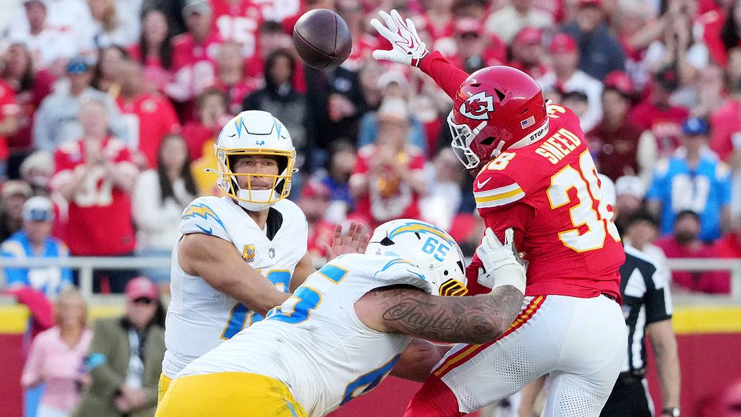 Oct 18, 2026; Kansas City, Missouri, USA;  Los Angeles Chargers quarterback Justin Herbert (10) throws a pass as Kansas City Chiefs cornerback L'Jarius Sneed (38) attempts to block during the third quarter at GEHA Field at Arrowhead Stadium.  Mandatory Credit: Denny Medley-Imagn Images