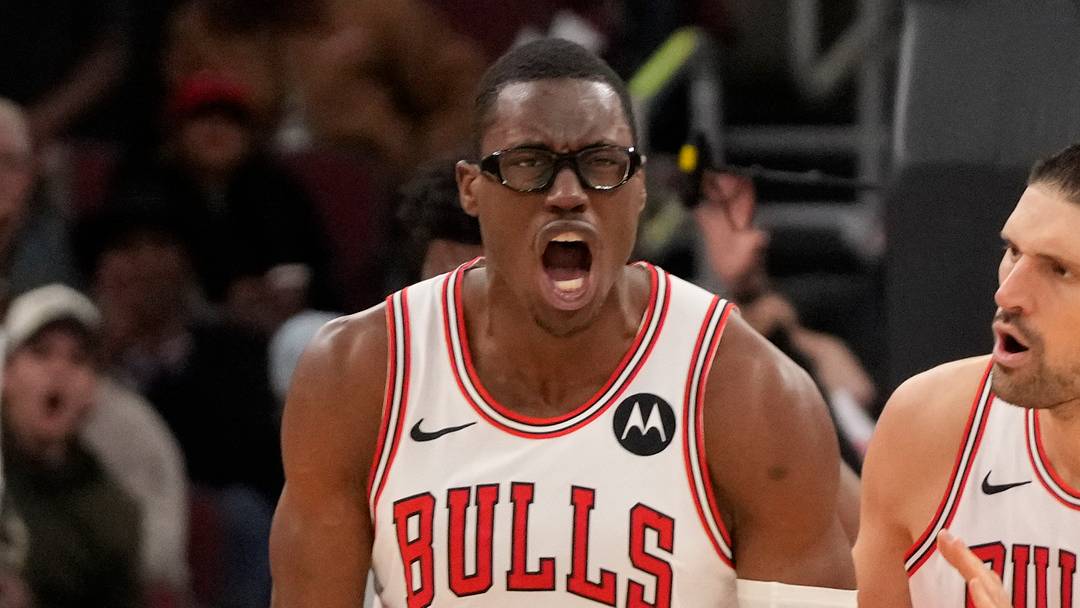 Chicago Bulls forward Jalen Smith (25) gestures after dunking the ball against the Philadelphia 76ers as center Nikola Vucevic (9) stands nearby during the second half at United Center. Mandatory Credit: David Banks-Imagn Images