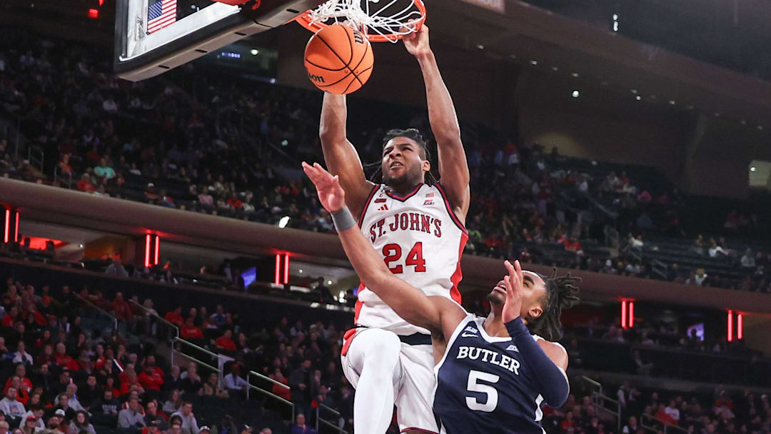 Jan 28, 2026; New York, New York, USA;  St. John's basketball forward Zuby Ejiofor (24) dunks past Butler Bulldogs forward Michael Ajayi (5) in the second half at Madison Square Garden.
