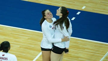 Apr 22, 2021; Omaha, Nebraska, USA; Wisconsin Badgers middle blocker Dana Rettke (16) and outside hitter Grace Loberg (21) celebrates with teammates in the second set against the Texas Longhorns at CHI Health Center Arena and Convention Center. Mandatory Credit: Steven Branscombe-Imagn Images