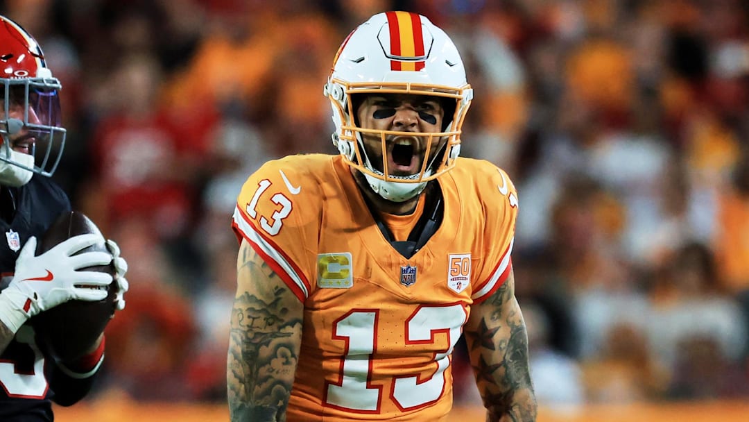 Dec 11, 2025; Tampa, Florida, USA; Tampa Bay Buccaneers wide receiver Mike Evans (13) reacts after catching a pass against Atlanta Falcons safety Jessie Bates III (3) (obscured) during the third quarter at Raymond James Stadium. Mandatory Credit: Kim Klement Neitzel-Imagn Images