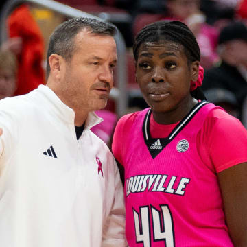 Louisville Cardinals head coach Jeff Walz talks to Olivia Cochran (44) during a foul shot during their game against the Pittsburgh Panthers on Sunday, Jan. 28, 2024 at KFC YUM Center.