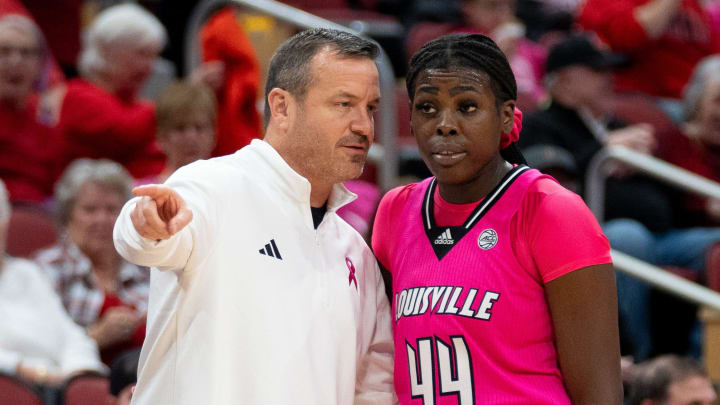 Louisville Cardinals head coach Jeff Walz talks to Olivia Cochran (44) during a foul shot during their game against the Pittsburgh Panthers on Sunday, Jan. 28, 2024 at KFC YUM Center.