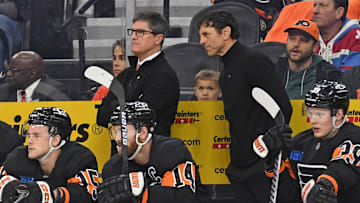 Mar 27, 2025; Philadelphia, Pennsylvania, USA; Philadelphia Flyers interim head coach Brad Shaw and assistant coach Rocky Thompson behind the bench against the Montreal Canadiens during the second period at Wells Fargo Center. Mandatory Credit: Eric Hartline-Imagn Images