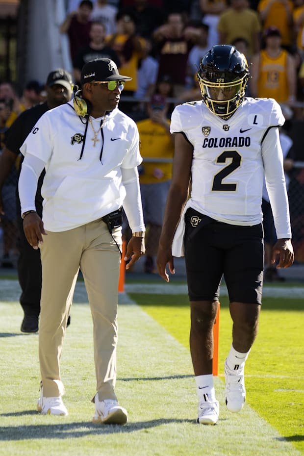 Oct 7, 2023; Tempe, Arizona, USA; Colorado Buffaloes head coach Deion Sanders with son and quarterback Shedeur Sanders (2) ag