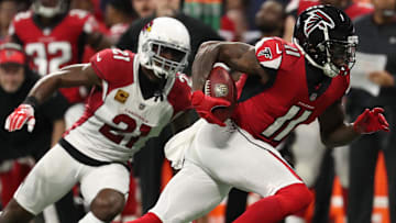 Dec 16, 2018; Atlanta, GA, USA; Atlanta Falcons wide receiver Julio Jones (11) runs after a catch against Arizona Cardinals cornerback Patrick Peterson (21) in the second quarter at Mercedes-Benz Stadium. Mandatory Credit: Jason Getz-Imagn Images