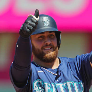 Seattle Mariners first baseman Tyler Locklear (27) gestures to the dugout after hitting a double during the seventh inning against the Kansas City Royals at Kauffman Stadium. 