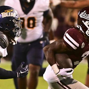 Mississippi State Bulldogs wide receiver Kevin Coleman Jr. (3) runs the ball while defended by Toledo Rockets linebacker Jackson Barrow (5) during the fourth quarter at Davis Wade Stadium at Scott Field. 