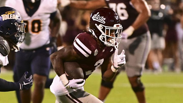 Mississippi State Bulldogs wide receiver Kevin Coleman Jr. (3) runs the ball while defended by Toledo Rockets linebacker Jackson Barrow (5) during the fourth quarter at Davis Wade Stadium at Scott Field. 