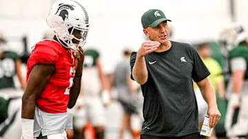 Michigan State's offensive coordinator Brian Lindgren, right, talks with quarterback Aidan Chiles during camp on Monday, Aug. 5, 2024, at the indoor practice facility in East Lansing.