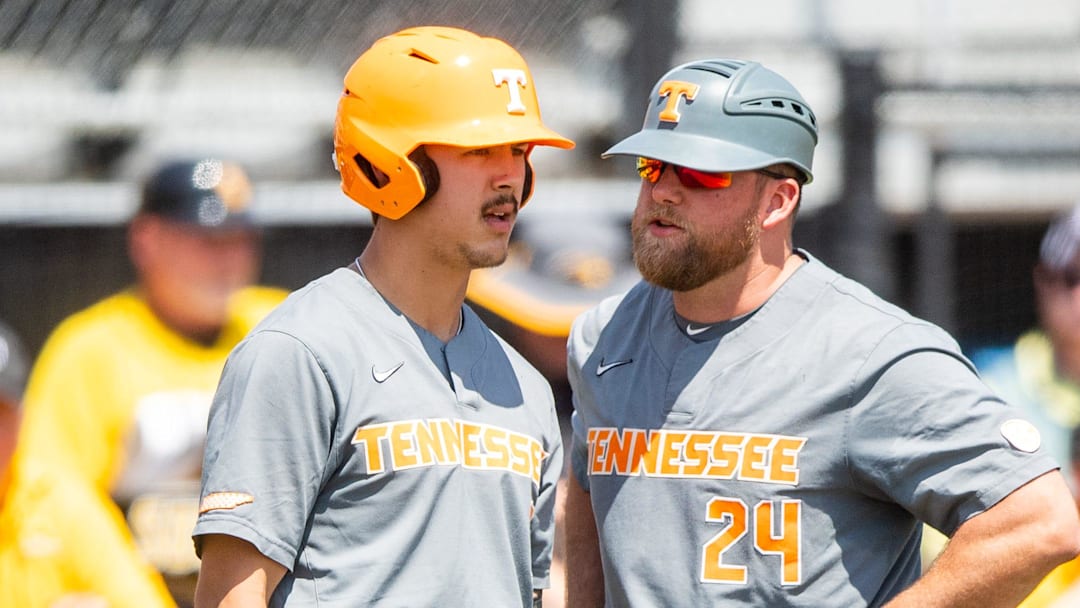 Tennessee assistant coach Josh Elander (24) speaks with Tennessee outfielder Hunter Ensley (9) during game one of the NCAA baseball super regional between Tennessee and Southern Mississippi held at Pete Taylor Park in Hattiesburg, Miss., on Sunday, June 11, 2023.