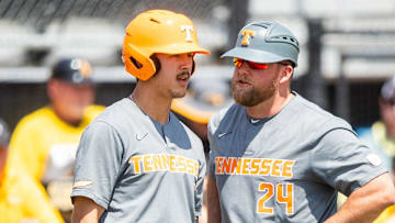 Tennessee assistant coach Josh Elander (24) speaks with Tennessee outfielder Hunter Ensley (9) during game one of the NCAA baseball super regional between Tennessee and Southern Mississippi held at Pete Taylor Park in Hattiesburg, Miss., on Sunday, June 11, 2023.