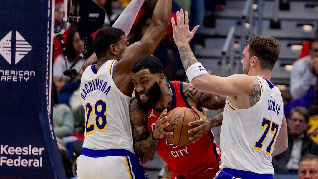 Nov 14, 2025; New Orleans, Louisiana, USA;  New Orleans Pelicans guard/forward Saddiq Bey (41) dribbles against Los Angeles Lakers forward Rui Hachimura (28) and forward/guard Luka Dončić (77) during the first half at Smoothie King Center. Mandatory Credit: Stephen Lew-Imagn Images
