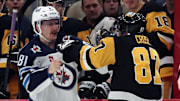 Nov 22, 2024; Pittsburgh, Pennsylvania, USA; Winnipeg Jets left wing Kyle Connor (81) and Pittsburgh Penguins center Sidney Crosby (87) fight during the second period at PPG Paints Arena. Mandatory Credit: Charles LeClaire-Imagn Images