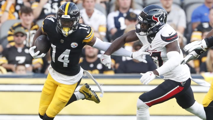 Aug 9, 2024; Pittsburgh, Pennsylvania, USA;  Pittsburgh Steelers wide receiver George Pickens (14) runs past Houston Texans cornerback Kris Boyd (17) after a catch during the first quarter at Acrisure Stadium. Mandatory Credit: Charles LeClaire-USA TODAY Sports