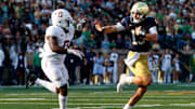 Notre Dame quarterback Riley Leonard (13) reaches out to stiff arm Stanford linebacker Gaethan Bernadel (0) during a NCAA college football game between Notre Dame and Stanford at Notre Dame Stadium on Saturday, Oct. 12, 2024, in South Bend.