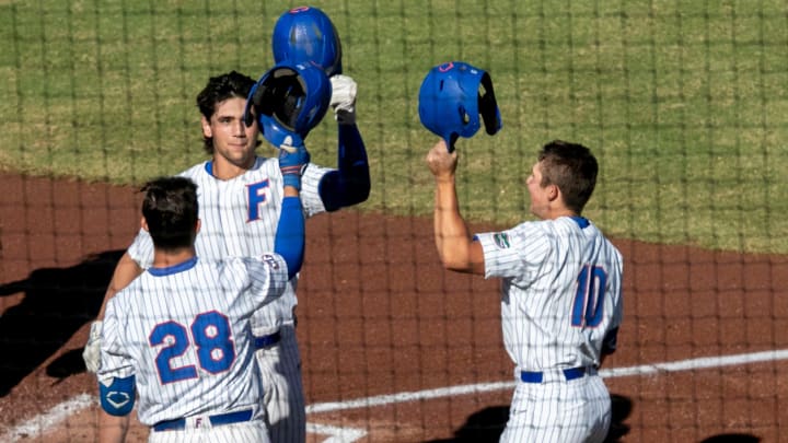 Florida's Jac Caglianone (14) celebrates his two-run homer against Stetson with Florida's catcher