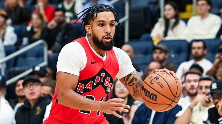 Oct 3, 2026; Quebec City, Quebec, CAN; Toronto Raptors guard Chucky Hepburn (24) dribbles the ball against Miami Heat forward Ian Schieffelin (20) during the fourth quarter at Videotron Centre. Mandatory Credit: David Kirouac-Imagn Images