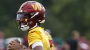 Jul 25, 2024; Ashburn, VA, USA; Washington Commanders quarterback Jayden Daniels (5) prepares to pass the ball during day two of Commanders training camp at OrthoVirginia Training Center at Commanders Park. Mandatory Credit: Geoff Burke-USA TODAY Sports