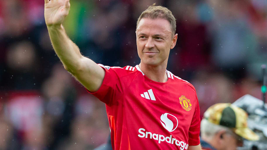 Jonny Evans waving to Man Utd crowd.