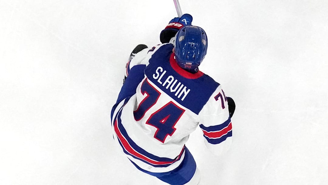 [US, Mexico & Canada customers only] Feb 15, 2026; Milan, Italy; Connor Hellebuyck of United States, Jaccob Slavin of United States, and Brock Faber of United States in action with John Peterka of Germany in men's ice hockey group C play during the Milano Cortina 2026 Olympic Winter Games at Milano Santagiulia Ice Hockey Arena. Mandatory Credit: Marton Monus/Reuters via Imagn Images