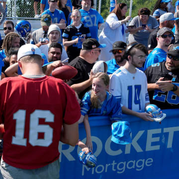 Detroit Lions quarterback Jared Goff signs items for fans