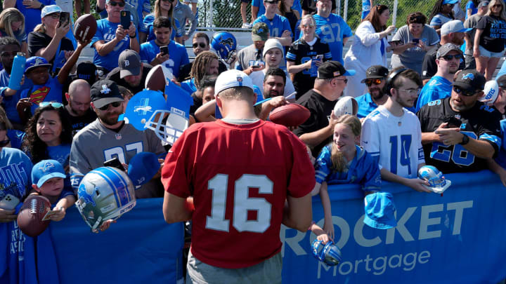 Detroit Lions quarterback Jared Goff signs items for fans