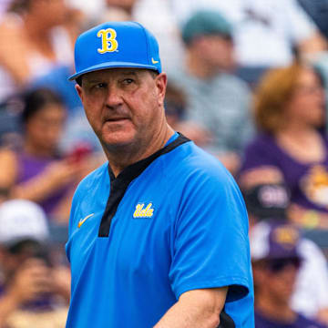 Jun 16, 2025; Omaha, Neb, USA; UCLA Bruins head coach John Savage walks off the field before the game against the LSU Tigers at Charles Schwab Field. Mandatory Credit: Dylan Widger-Imagn Images