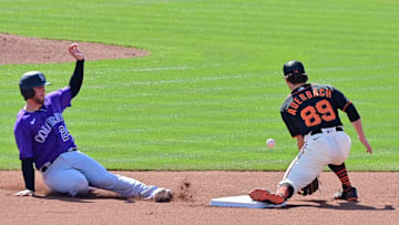 Mar 3, 2023; Scottsdale, Arizona, USA; Colorado Rockies third baseman Ryan McMahon (24) steals second base on San Francisco Giants second baseman Brett Auerbach (89) in the fourth inning during a Spring Training game at Scottsdale Stadium. Mandatory Credit: Matt Kartozian-Imagn Images