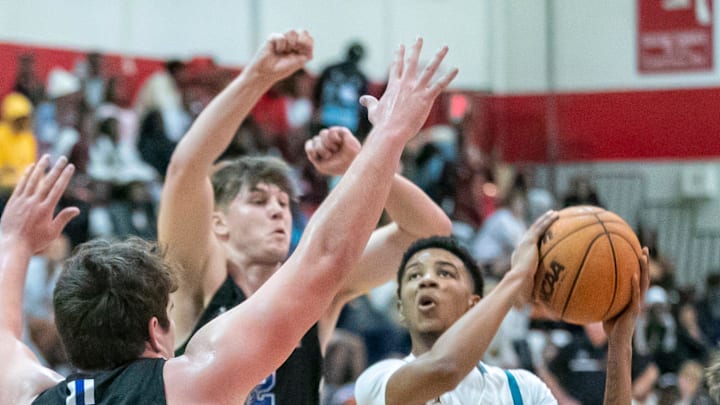 Olympia High School Cam Miles (4) ties to drive by Covington Catholic center Aiden Jones (40) and Covington Catholic guard Evan Ipsaro (2) as Covington Catholic takes on Olympia High School in the Kingdom of the Sun basketball tourney  Wednesday, Dec. 28, 2022, at Vanguard High School in Ocala, Fla. [Alan Youngblood/\Ocala Star-Banner]

Kingdom Of The Sun Opening Day