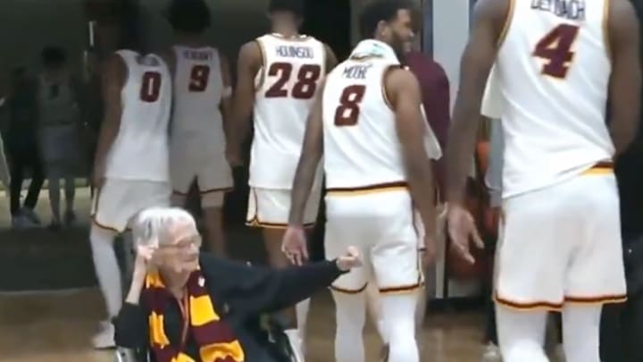 Sister Jean attempts to give a fist bump. 