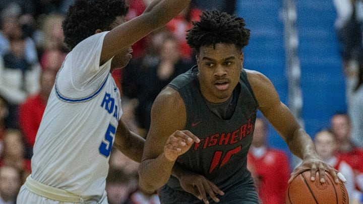 Fishers High School's guard Jalen Haralson (10) is defended by Hamilton Southeastern High School's guard Deion Miles (5) at Carmel High School, Tuesday, Feb. 28, 2023, during the Fishers boys    sectional win over HSE, 68-49.