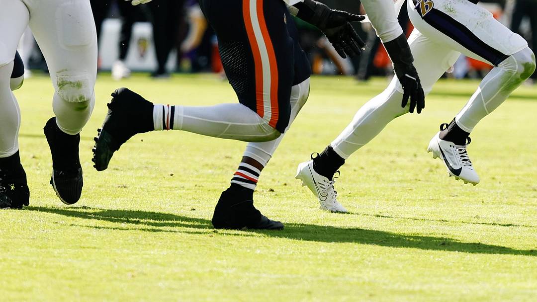 Oct 26, 2025; Baltimore, Maryland, USA; Baltimore Ravens quarterback Tyler Huntley (5) runs with the ball as Chicago Bears defensive end Dayo Odeyingbo (55) chases in the third quarter at M&T Bank Stadium. Mandatory Credit: Geoff Burke-Imagn Images