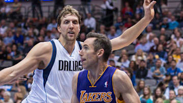 Nov 5, 2013; Dallas, TX, USA; Los Angeles Lakers point guard Steve Nash (10) drives to the basket past Dallas Mavericks power forward Dirk Nowitzki (41) during the game at the American Airlines Center. The Mavericks defeated the Lakers 123-104. 