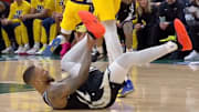 Milwaukee Bucks' Damian Lillard grabs at his leg after suffering an injury vs. the Indiana Pacers.