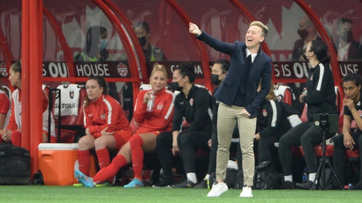 Women's Canadian National team head coach Bev Priestman reacts on the side of the pitch.