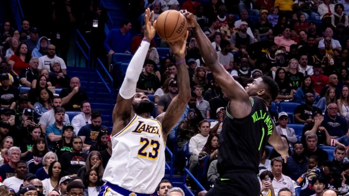 Apr 14, 2024; New Orleans, Louisiana, USA; New Orleans Pelicans forward Zion Williamson (1) blocks the shot attempt of Los Angeles Lakers forward LeBron James (23) during the second half at Smoothie King Center. 