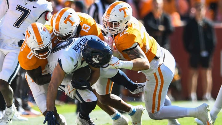 UConn wide receiver Brett Buckman (10) is tackles by Tennessee defensive back Doneiko Slaughter (0), Tennessee defensive back Wesley Walker (13) and Tennessee linebacker Jeremiah Telander (22) during the Tennessee football game against UConn at Neyland Stadium in Knoxville, Tenn., on Saturday, Nov. 4, 2023.