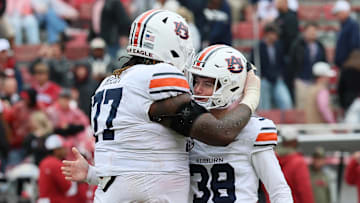 Oct 25, 2025; Fayetteville, Arkansas, USA; Auburn Tigers offensive lineman Jeremiah Wright (77) celebrates with kicker Alex McPherson (38) after a field goal late in the fourth quarter against the Arkansas Razorbacks at Donald W. Reynolds Razorback Stadium. Auburn won 33-24. Mandatory Credit: Nelson Chenault-Imagn Images
