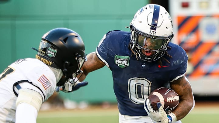 UConn's Cam Edwards carries the ball during a game vs. Army in the Fenway Bowl at Fenway Park in Boston on Saturday, Dec. 27, 2025.