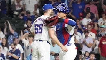Aug 4, 2024; Chicago, Illinois, USA; Chicago Cubs pitcher Julian Merryweather (66) and catcher Miguel Amaya (9) celebrate their win against the St. Louis Cardinals at Wrigley Field. Mandatory Credit: David Banks-Imagn Images