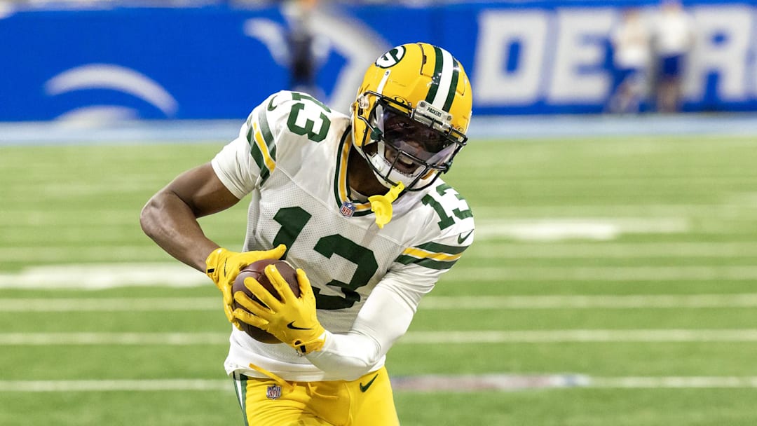 Dec 5, 2024; Detroit, Michigan, USA; Green Bay Packers wide receiver Dontayvion Wicks (13) runs with the ball after a catch during the third quarter of the game against the Detroit Lions at Ford Field. Mandatory Credit: David Reginek-Imagn Images
