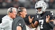 Nov 23, 2025; Paradise, Nevada, USA; Las Vegas Raiders quarterback Geno Smith (7) talks with head coach Pete Carroll and quarterbacks coach Greg Olsen in a game against the Cleveland Browns during the fourth quarter at Allegiant Stadium. Mandatory Credit: Stephen R. Sylvanie-Imagn Images