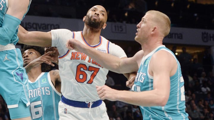 Mar 23, 2022; Charlotte, North Carolina, USA; Charlotte Hornets guard LaMelo Ball (2) grabs a rebound in front of New York Knicks center forward Taj Gibson (67) during the first half at the Spectrum Center. Mandatory Credit: Sam Sharpe-USA TODAY Sports